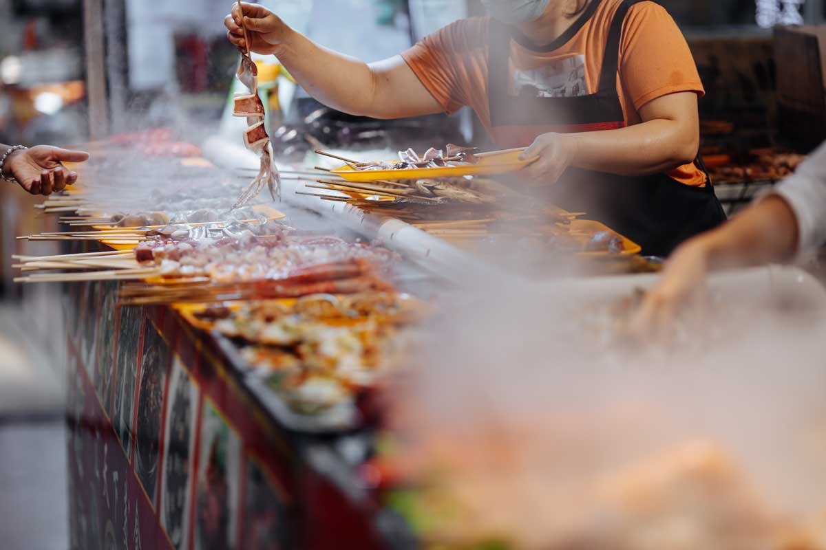 Street Food market with fresh meal for tourists. Traditional asian cuisine concept.